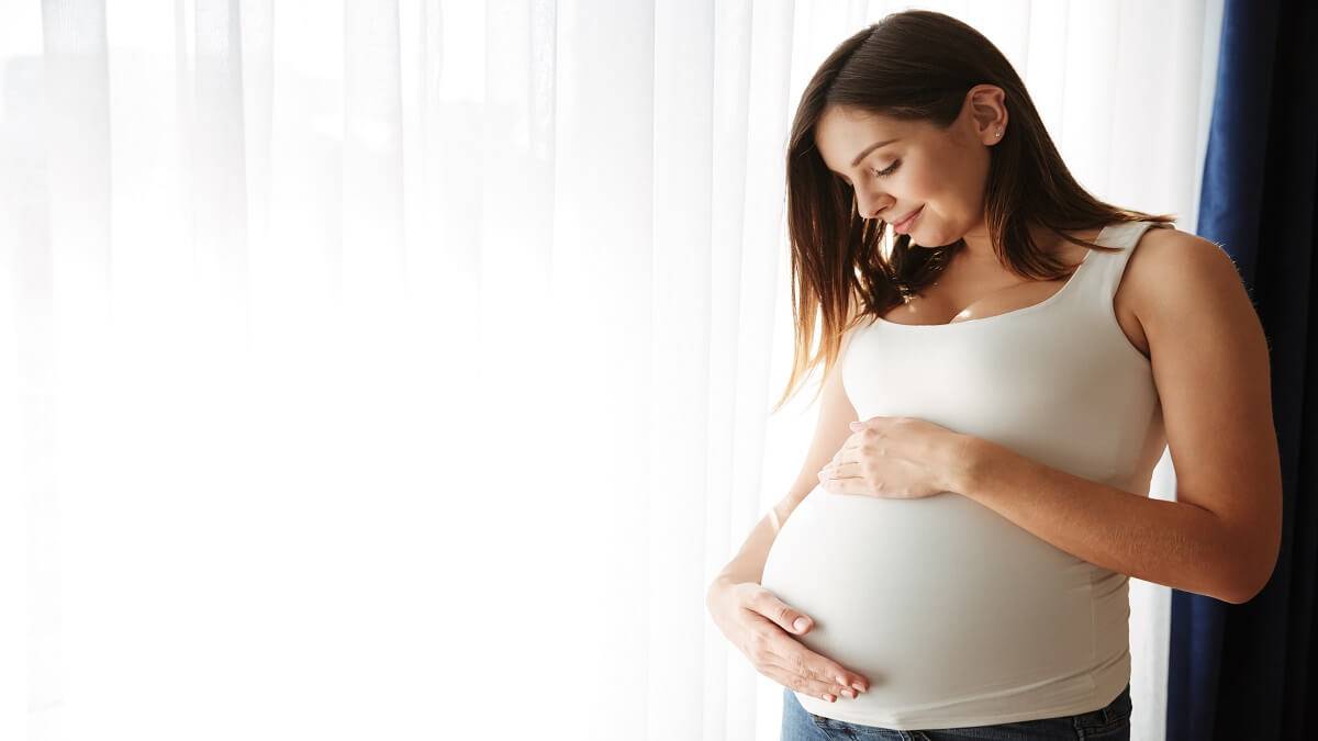portrait happy pregnant woman touching her belly